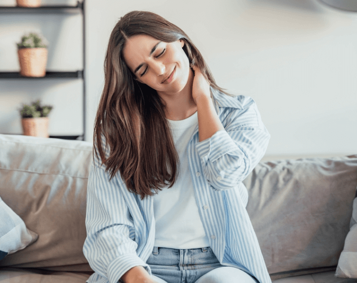 Young woman with neck discomfort indoors